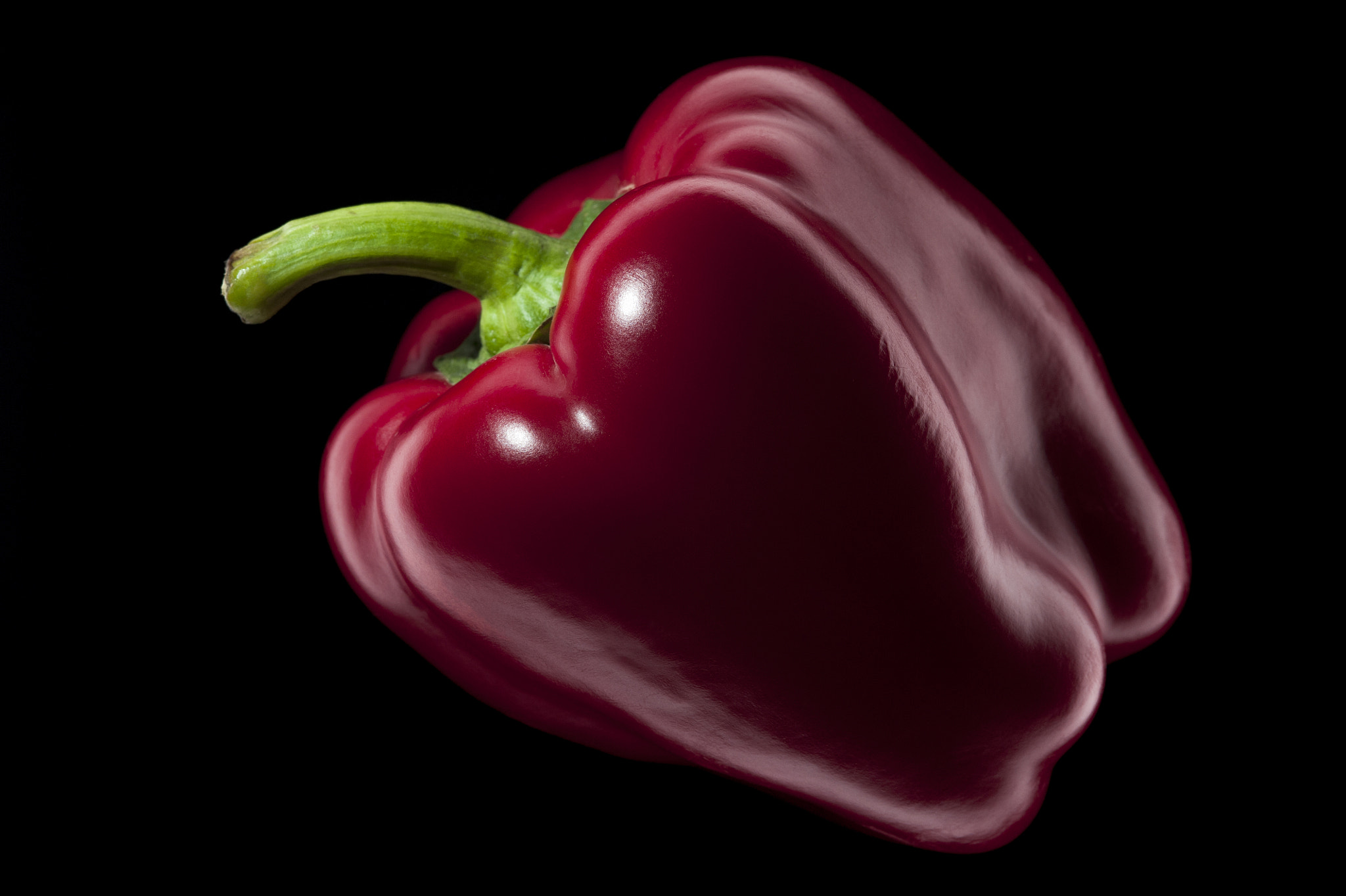 Nikon D700 + AF Micro-Nikkor 105mm f/2.8 sample photo. Red bell pepper on black background photography