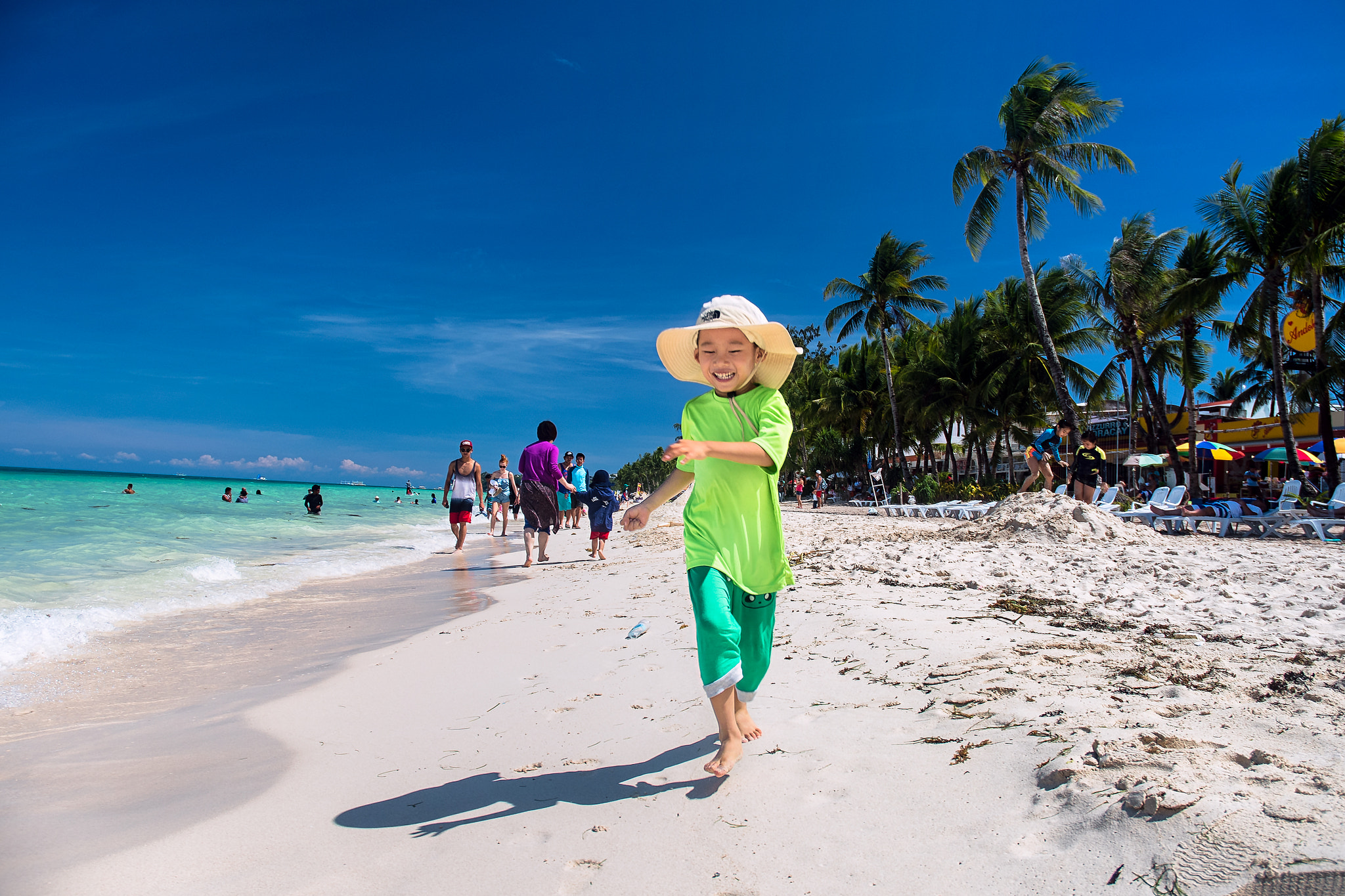 Nikon D750 + Nikon AF-S DX Nikkor 18-70mm F3.5-4.5G ED-IF sample photo. My son run at the white beach photography