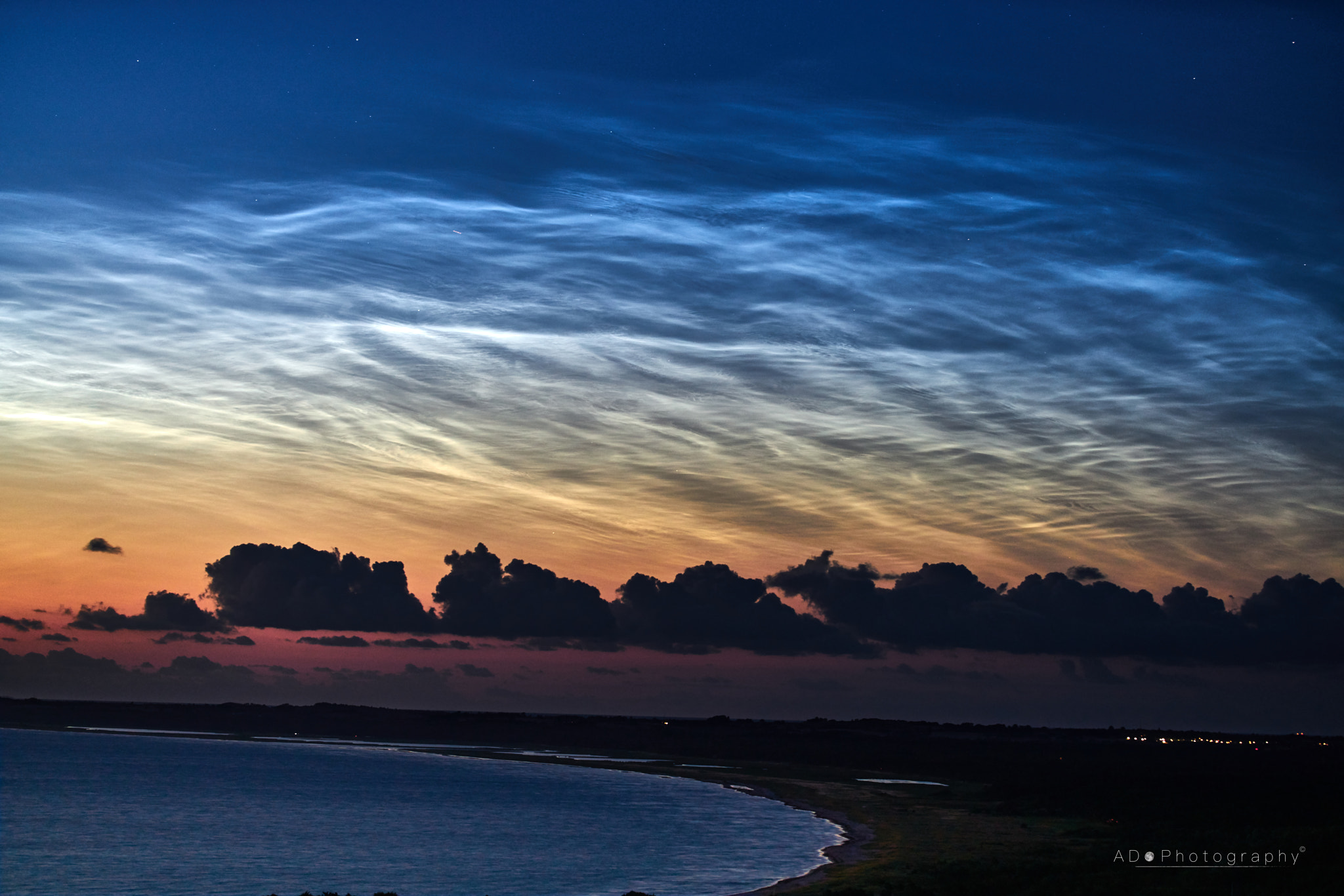 100mm F2.8 G SSM OSS sample photo. Bay lit up by the noctilucent clouds photography