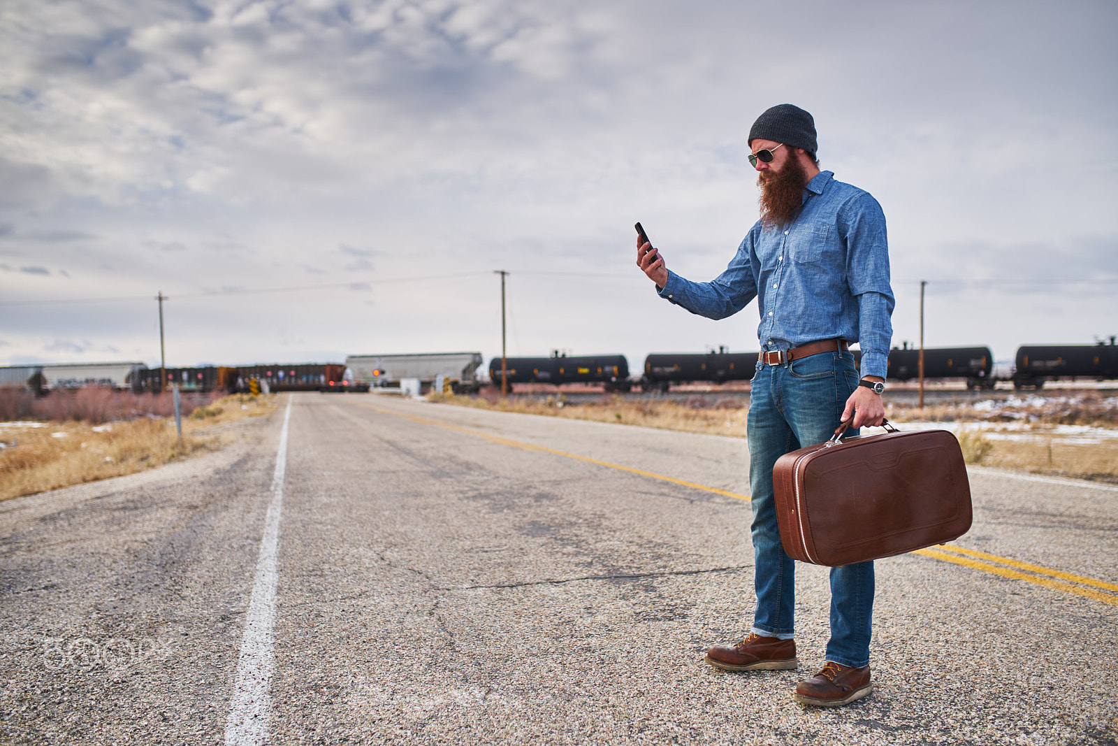 35mm F1.4 G SSM sample photo. Lost bearded hitch hiker with smart phone looking for directions on desolate nevada road photography