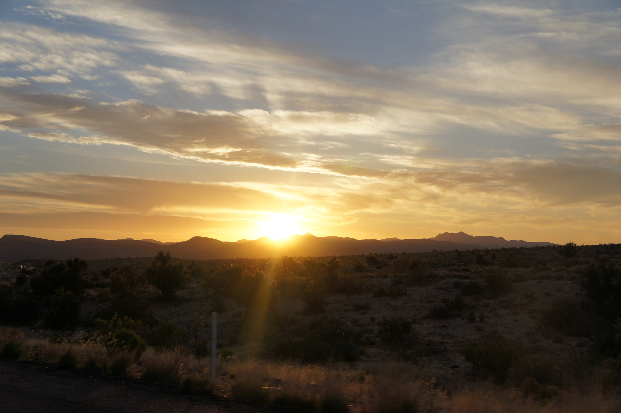 Sony Alpha NEX-3 + Sony E 18-55mm F3.5-5.6 OSS sample photo. Sun peeking over mountains photography