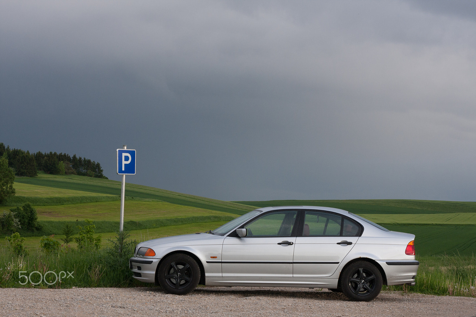 Sigma 17-70mm F2.8-4 DC Macro OS HSM sample photo. Silver car parking on a green field photography