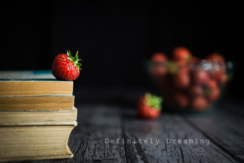 Sony a99 II + Sigma 30mm F1.4 EX DC HSM sample photo. Pile of books with a strawberry on top photography
