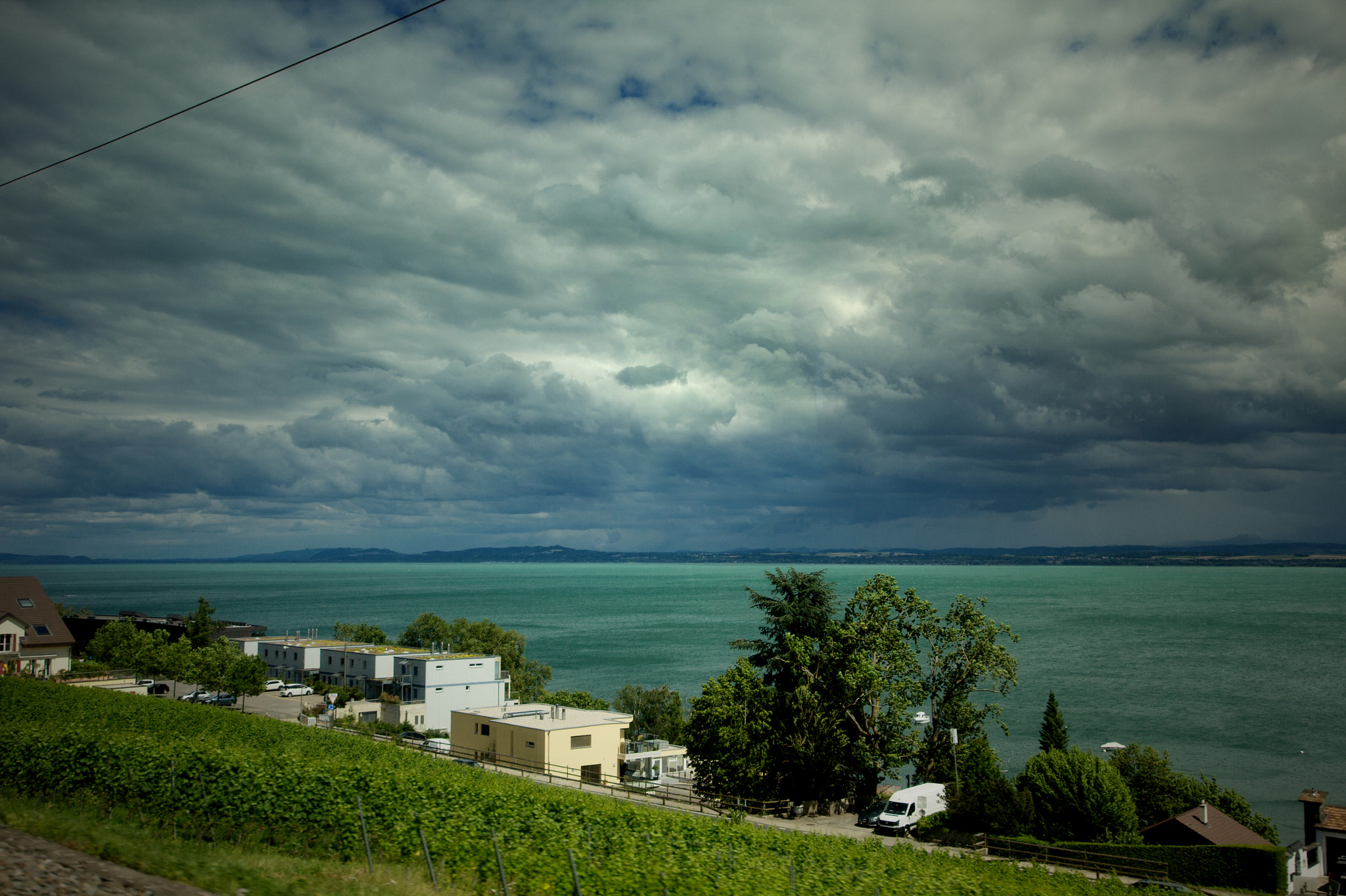 Canon EOS 60D + Sigma 12-24mm F4.5-5.6 II DG HSM sample photo. View from the train on neuchâtel's lake photography