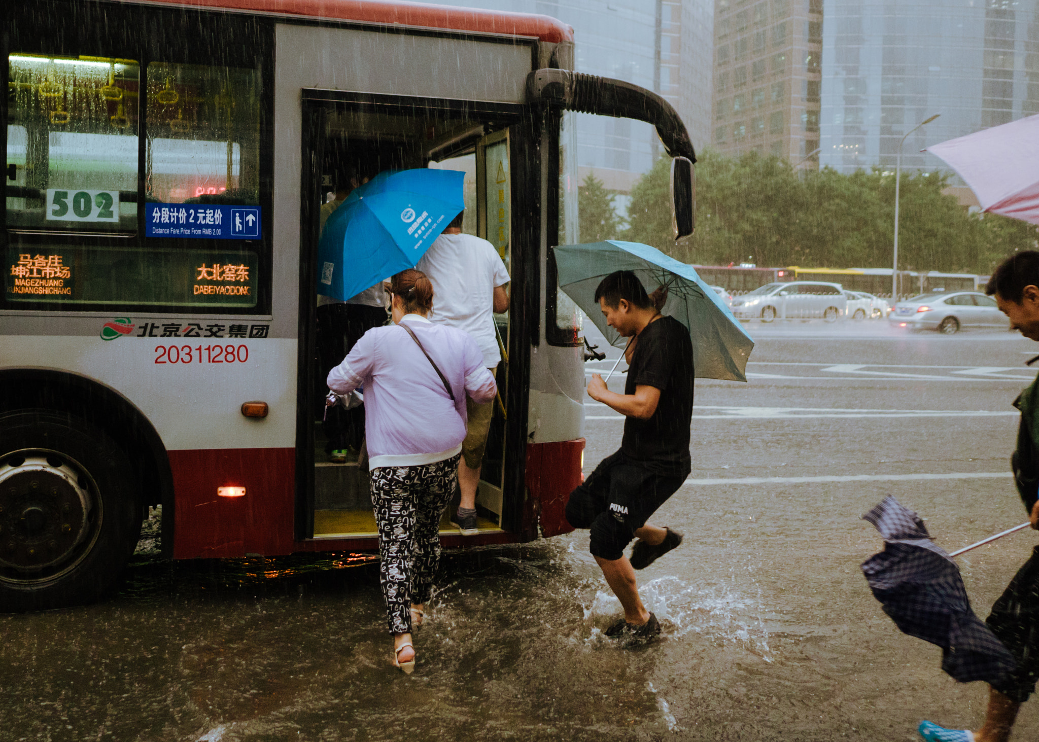 Panasonic DMC-GM1S sample photo. Catch a bus in a rainstorm photography