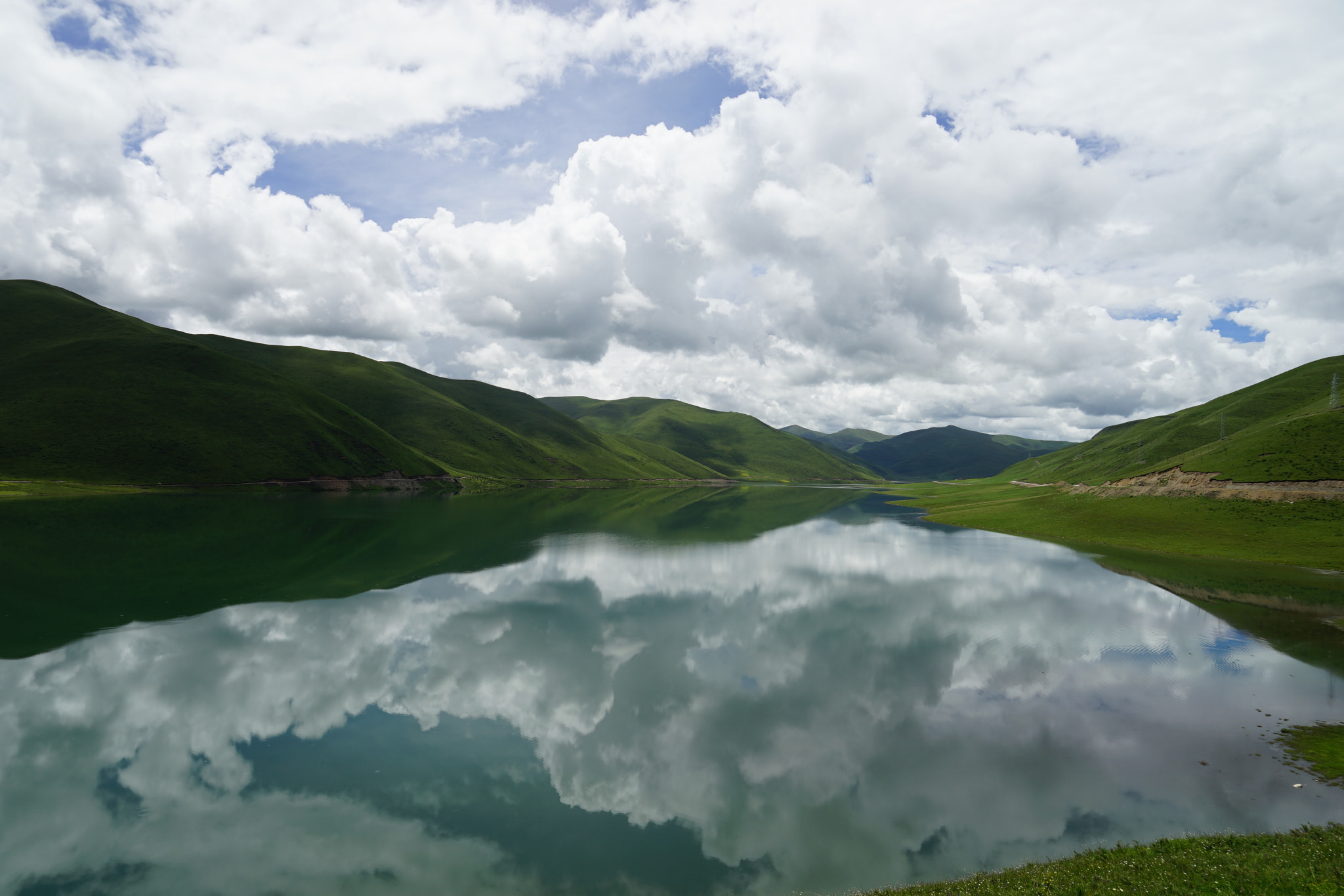Sony FE 24-240mm F3.5-6.3 OSS sample photo. Mountains, clouds, water, and reflections photography