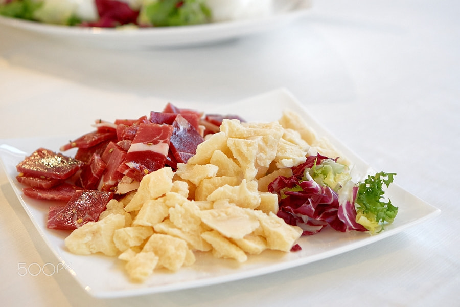 E 50mm F1.8 OSS sample photo. Parmesan cheese, cold cuts and red chicory salad in a plate photography