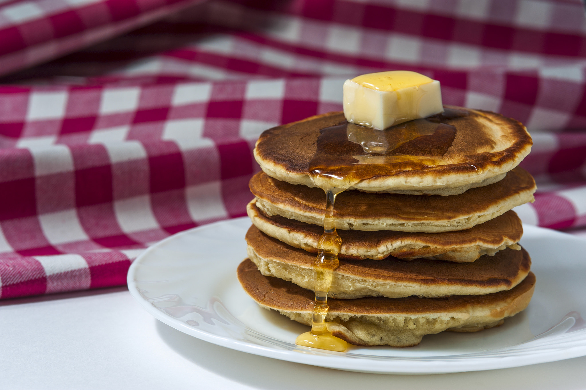 Nikon D700 + AF Micro-Nikkor 105mm f/2.8 sample photo. Pancakes with butter and honey on white plate photography
