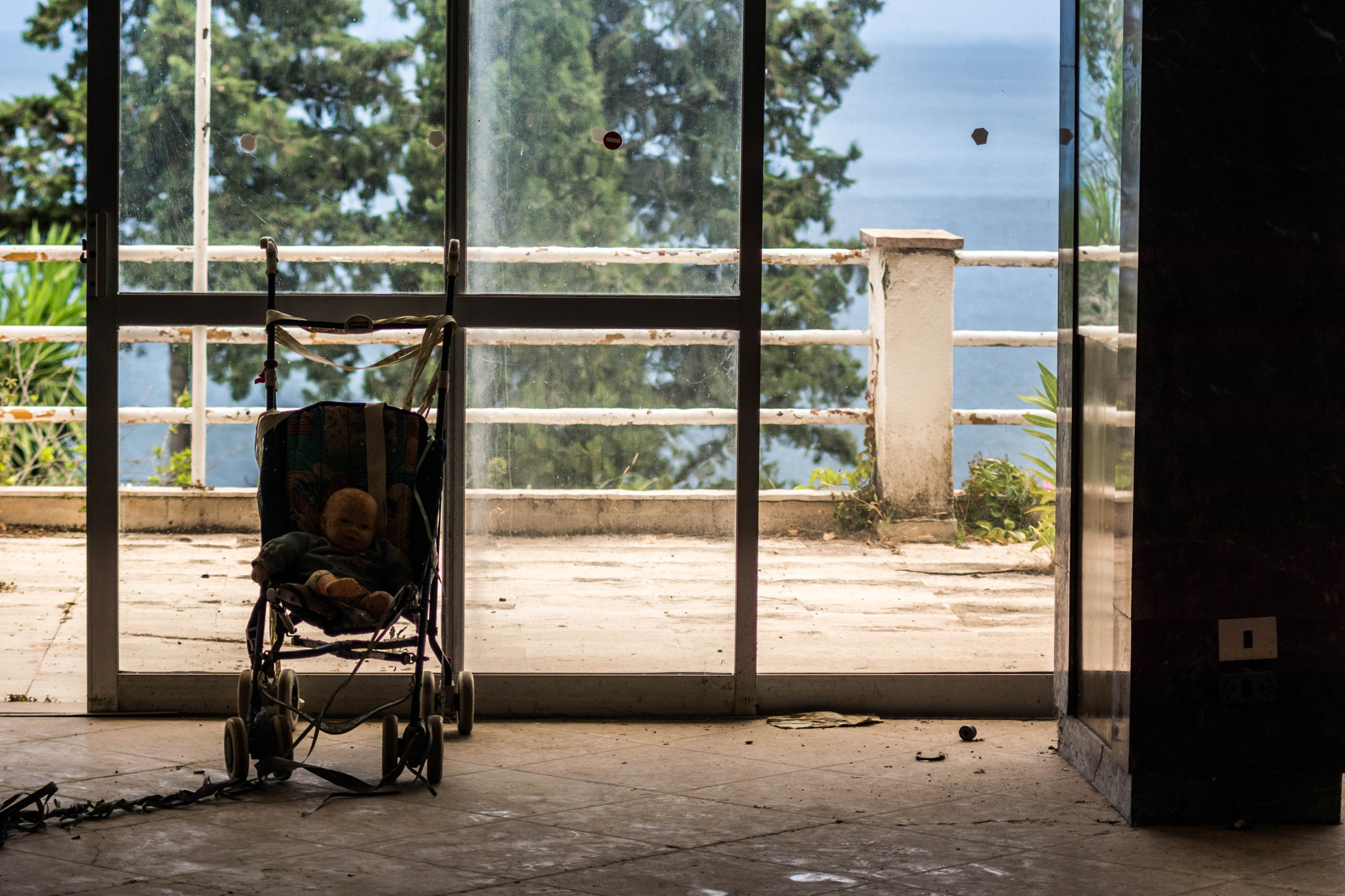 Sony ILCA-77M2 + Minolta AF 70-210mm F4 Macro sample photo. Stroller in an abandoned hotel photography