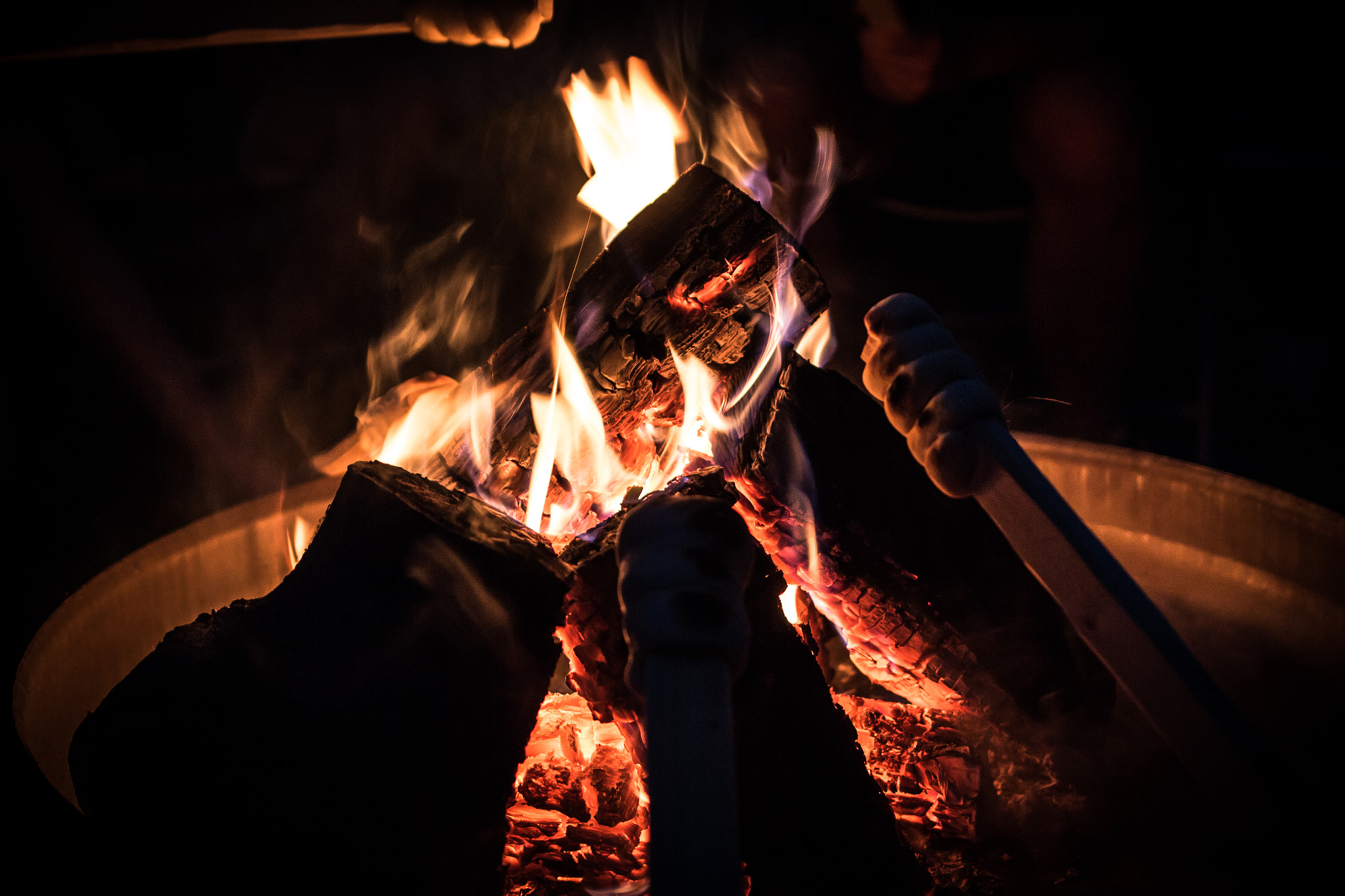 Canon EF 35mm F2 IS USM sample photo. Baking bread on a stick over an open fire photography