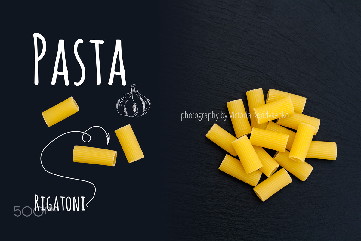 Canon EOS 1000D (EOS Digital Rebel XS / EOS Kiss F) sample photo. Uncooked italian pasta rigatoni on black slate stone background photography