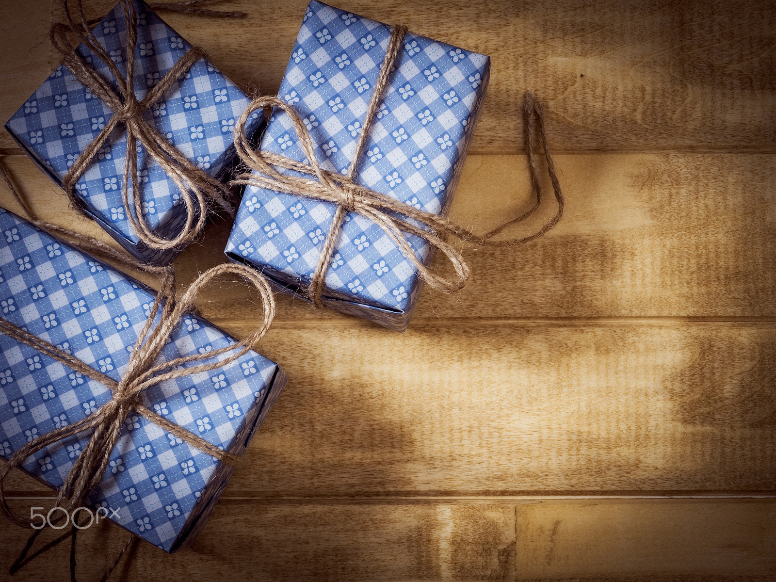 Olympus OM-D E-M1 + OLYMPUS 50mm Lens sample photo. Gift boxes in blue paper on the wooden table photography