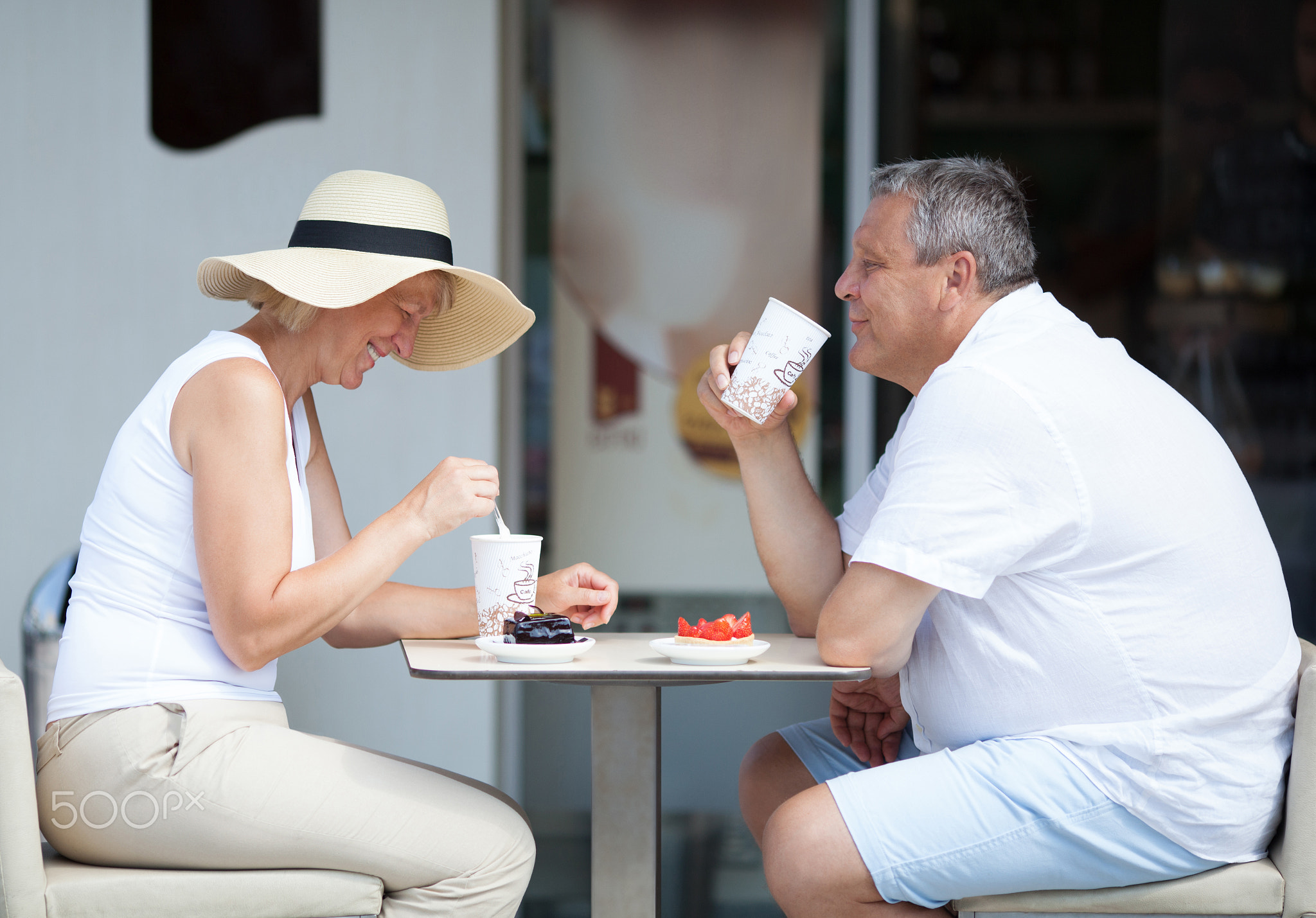 Couple Enjoying Coffee and Desserts on Cafe Patio