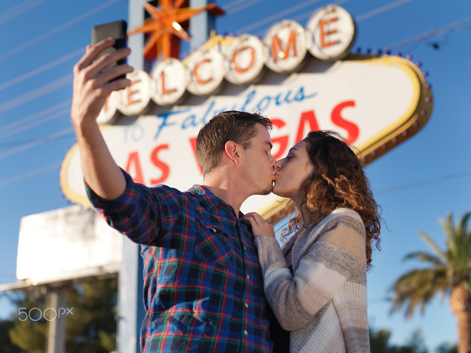 Hasselblad H3DII-39 sample photo. Romantic couple kiss in front of las vegas sign while taking a selfie photography