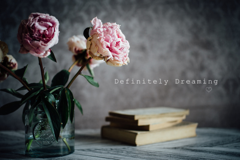 Sony a99 II + Sigma 30mm F1.4 EX DC HSM sample photo. Jar of dying peonies with pile of books photography