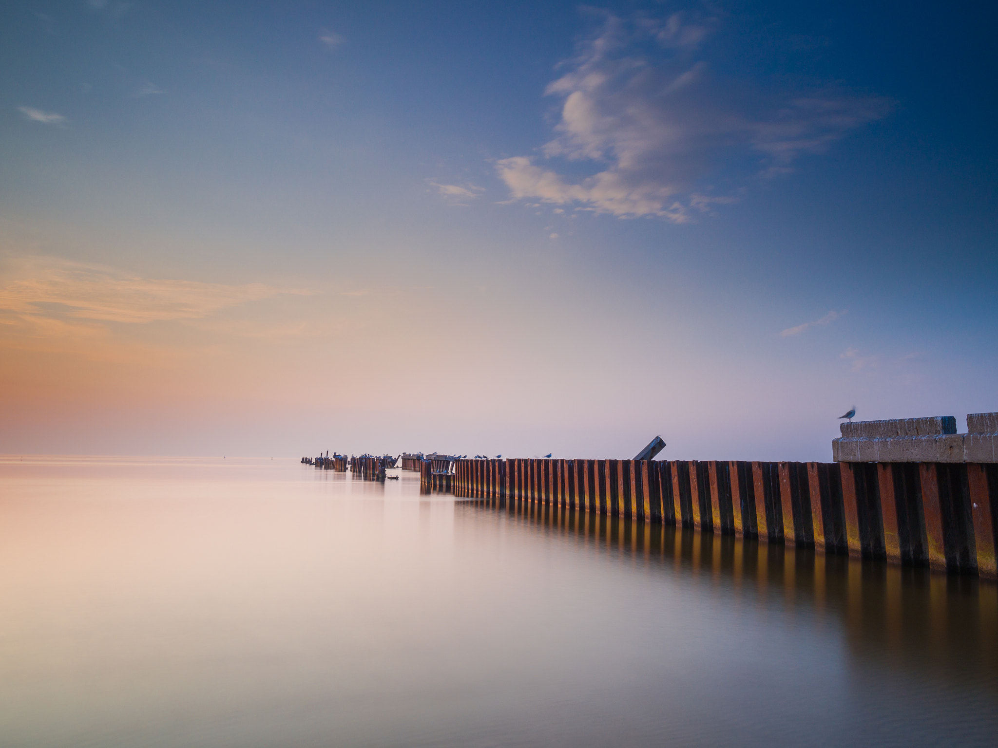 Olympus OM-D E-M5 + Olympus M.Zuiko Digital ED 7-14mm F2.8 PRO sample photo. Evening sunset on an old pier. photography