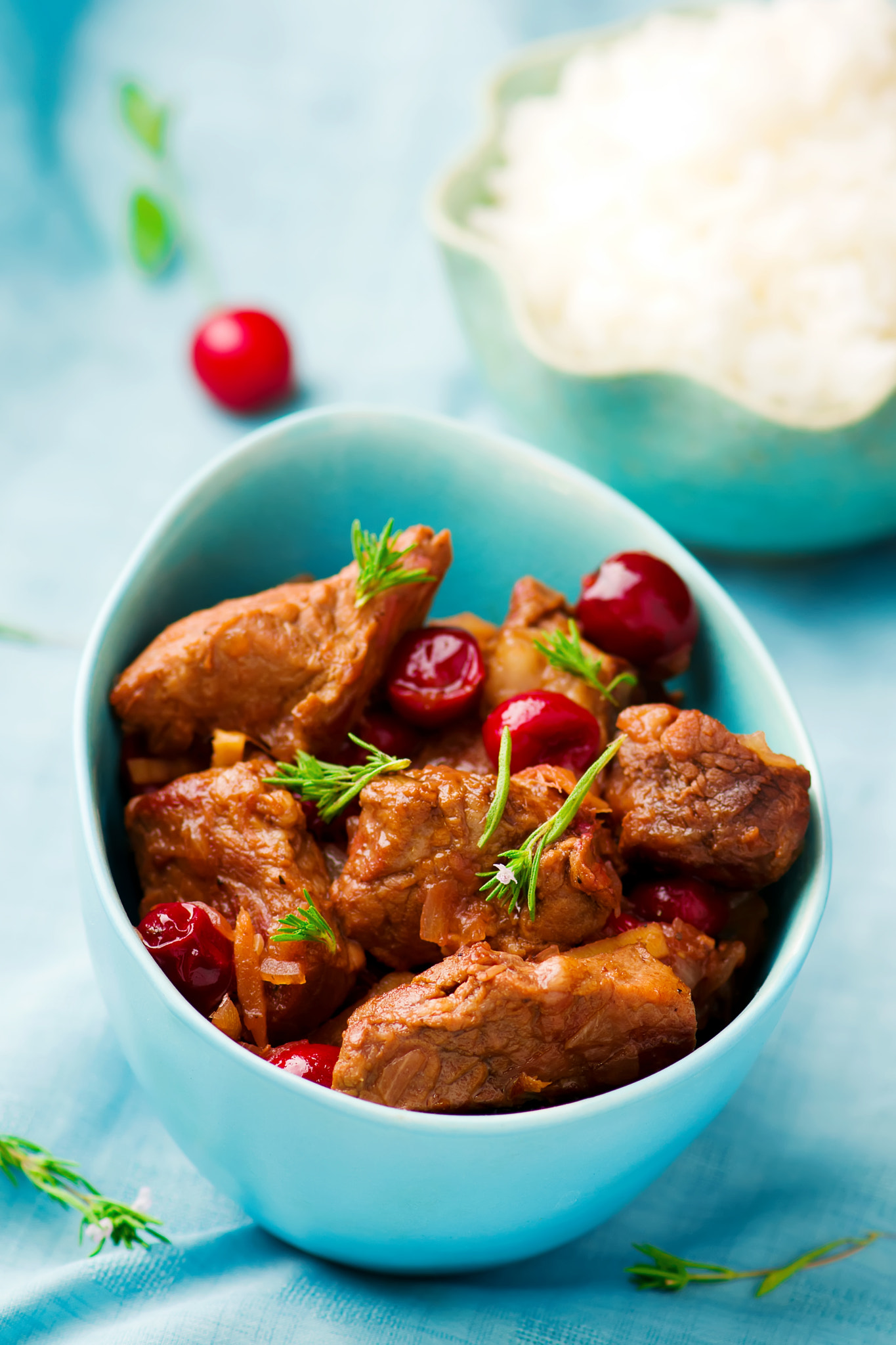 stewed pork with cherry in a blue bowl