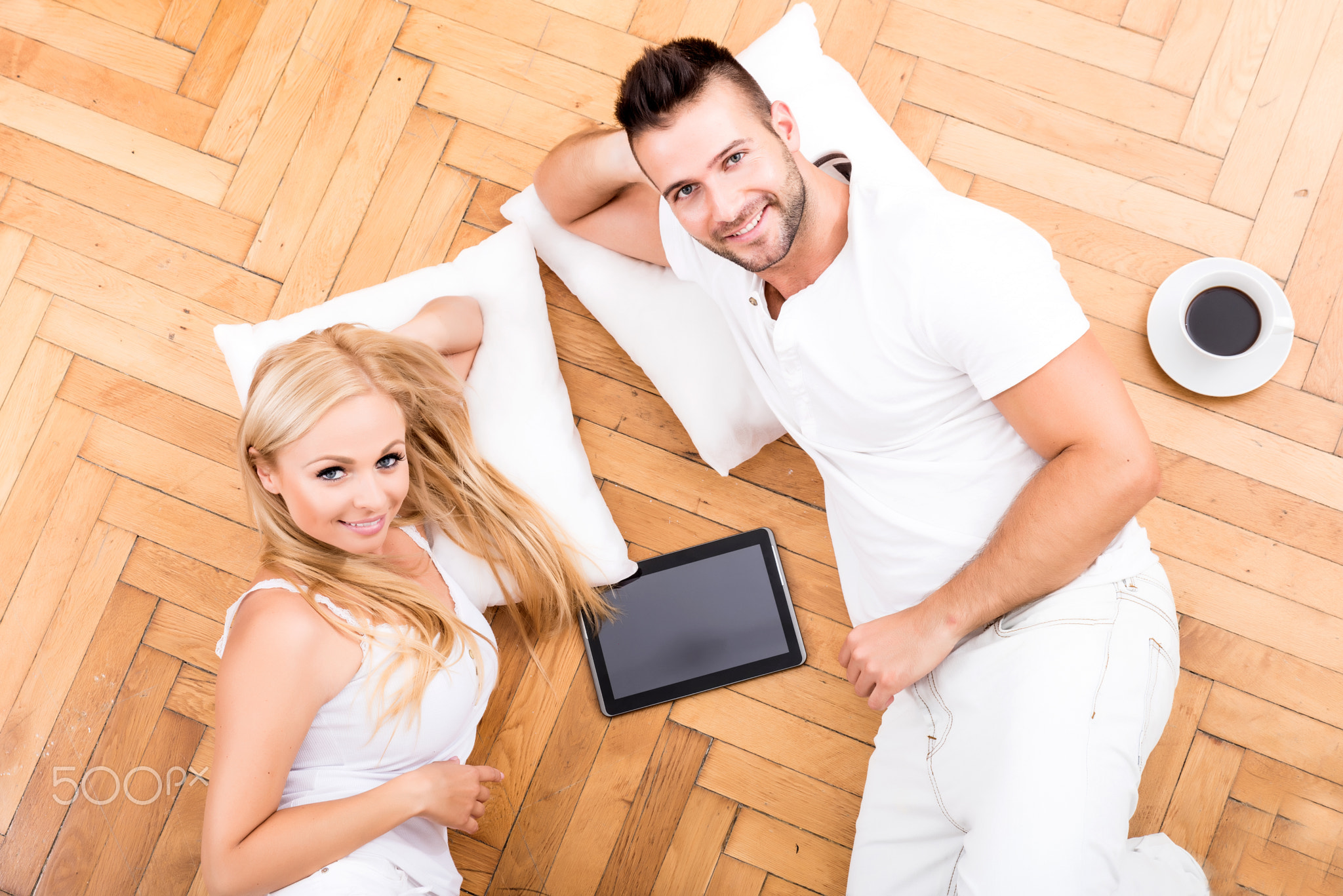 A beautiful young couple on the floor in their new home
