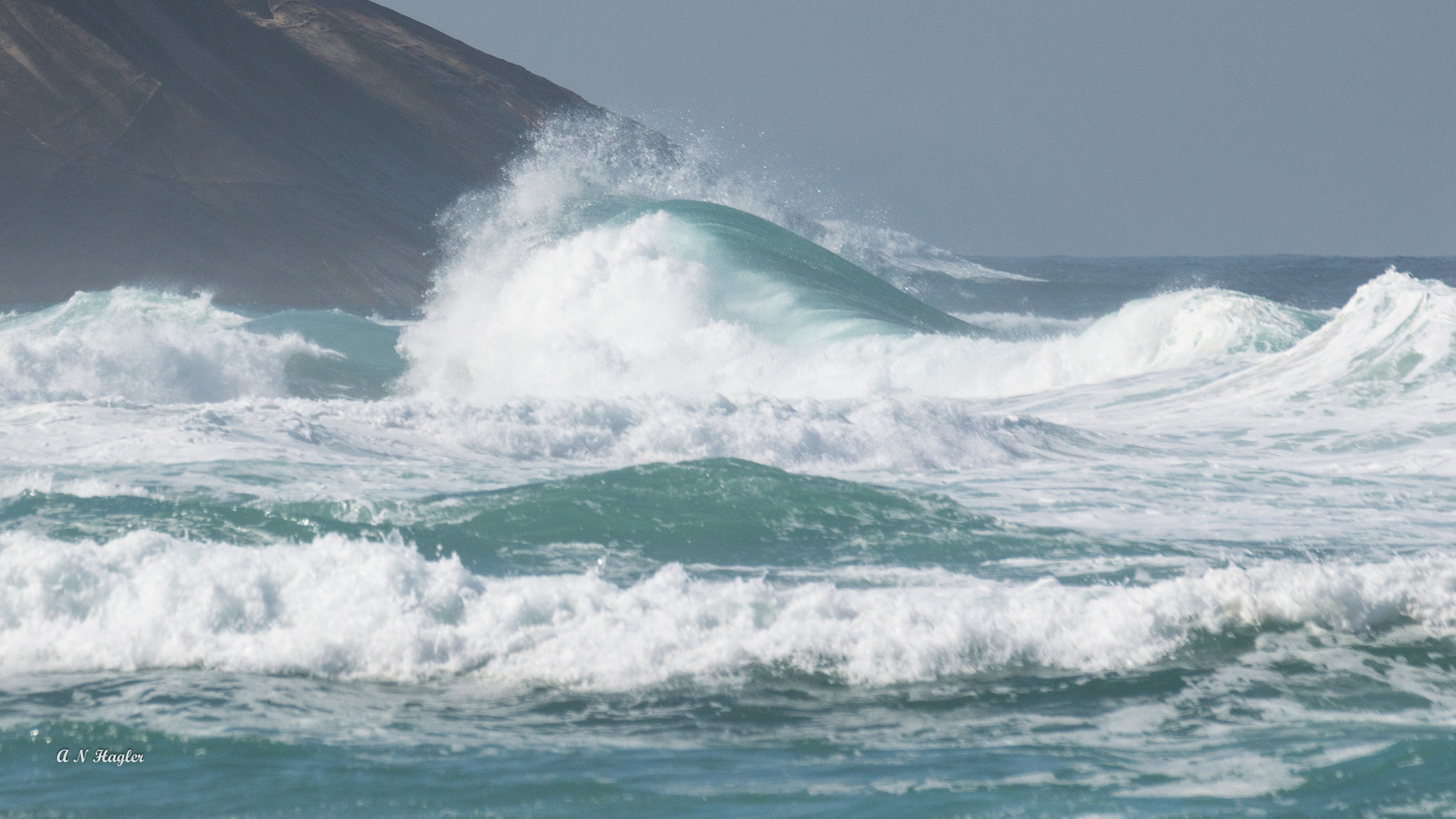 Sony 70-300mm F4.5-5.6 G SSM sample photo. Breakers in sun on rock photography