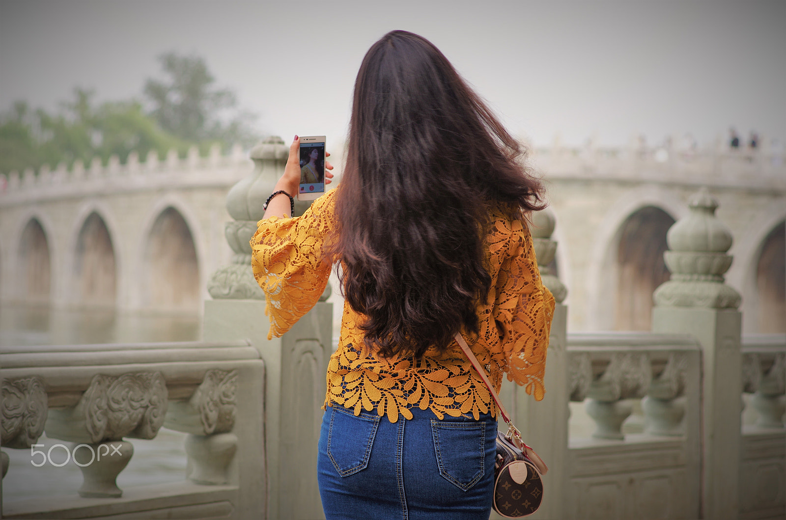 Pentax K-5 IIs sample photo. A girl taking a photo by an acient bridge photography