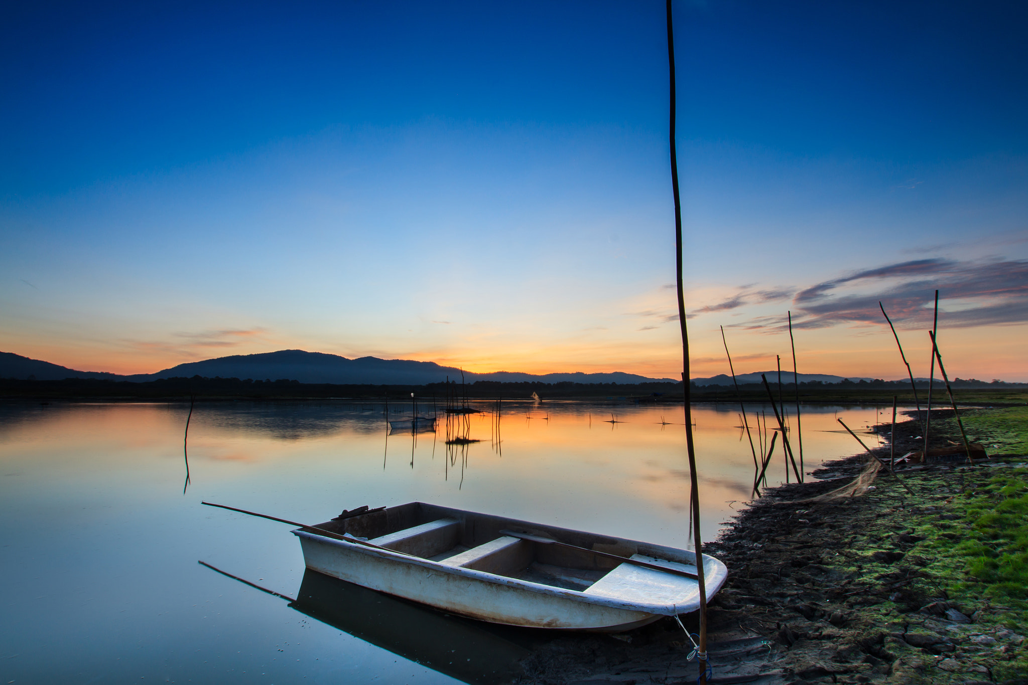 Sigma 10-20mm F3.5 EX DC HSM sample photo. Fishing boat in lake with beautiful dawn light background. photography