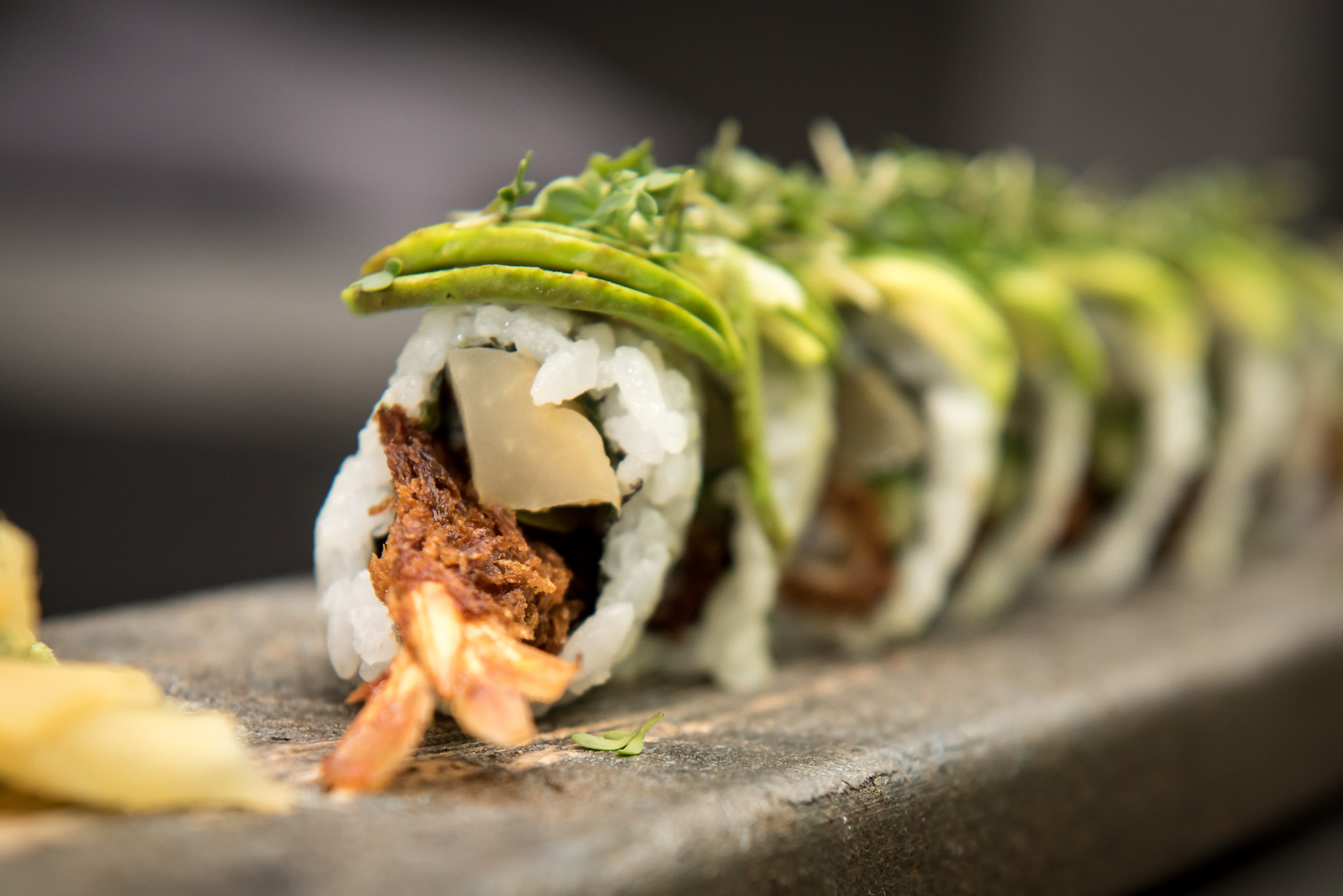 Sushi rolls with prawns on a stone plate