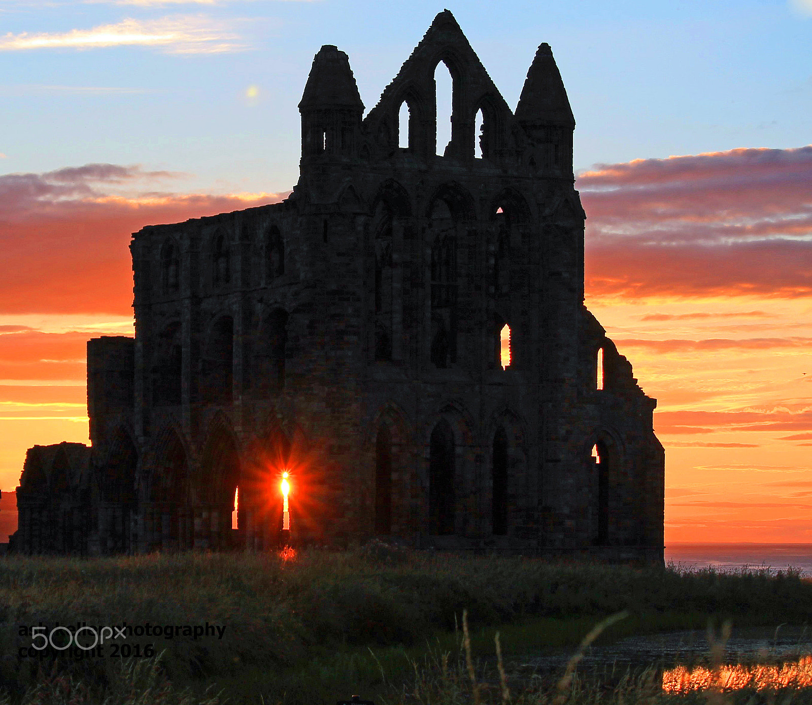 Canon EOS 1100D (EOS Rebel T3 / EOS Kiss X50) + Canon EF-S 55-250mm F4-5.6 IS STM sample photo. Sunset through the window at whitby abbey photography
