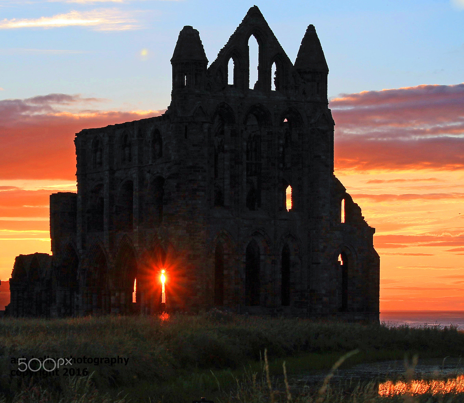 Canon EF-S 55-250mm F4-5.6 IS STM sample photo. Sunset through the window at whitby abbey photography