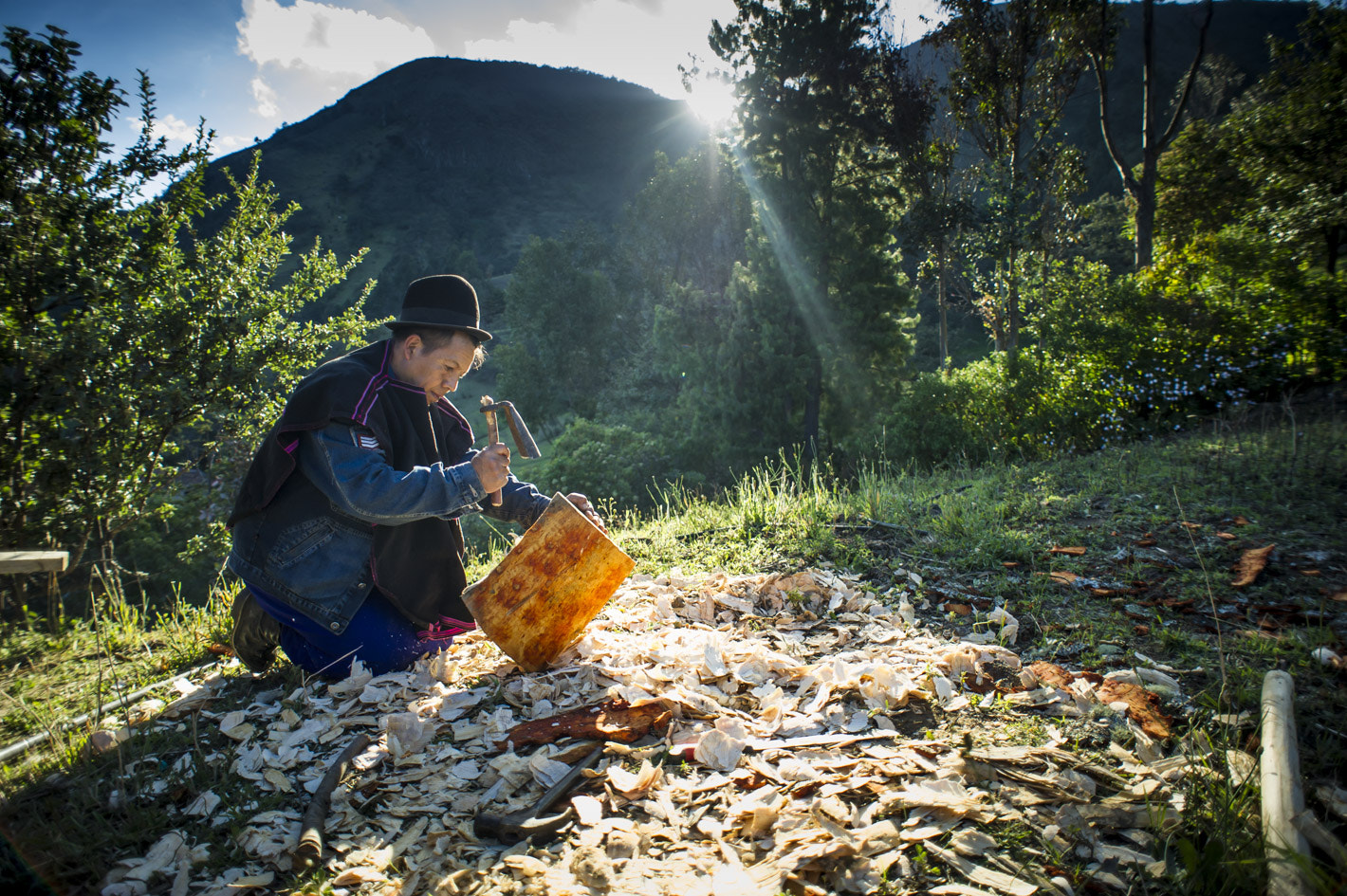 Nikon D3S + Nikon AF Nikkor 20mm F2.8D sample photo. Man guambian community working with wood in cauc photography