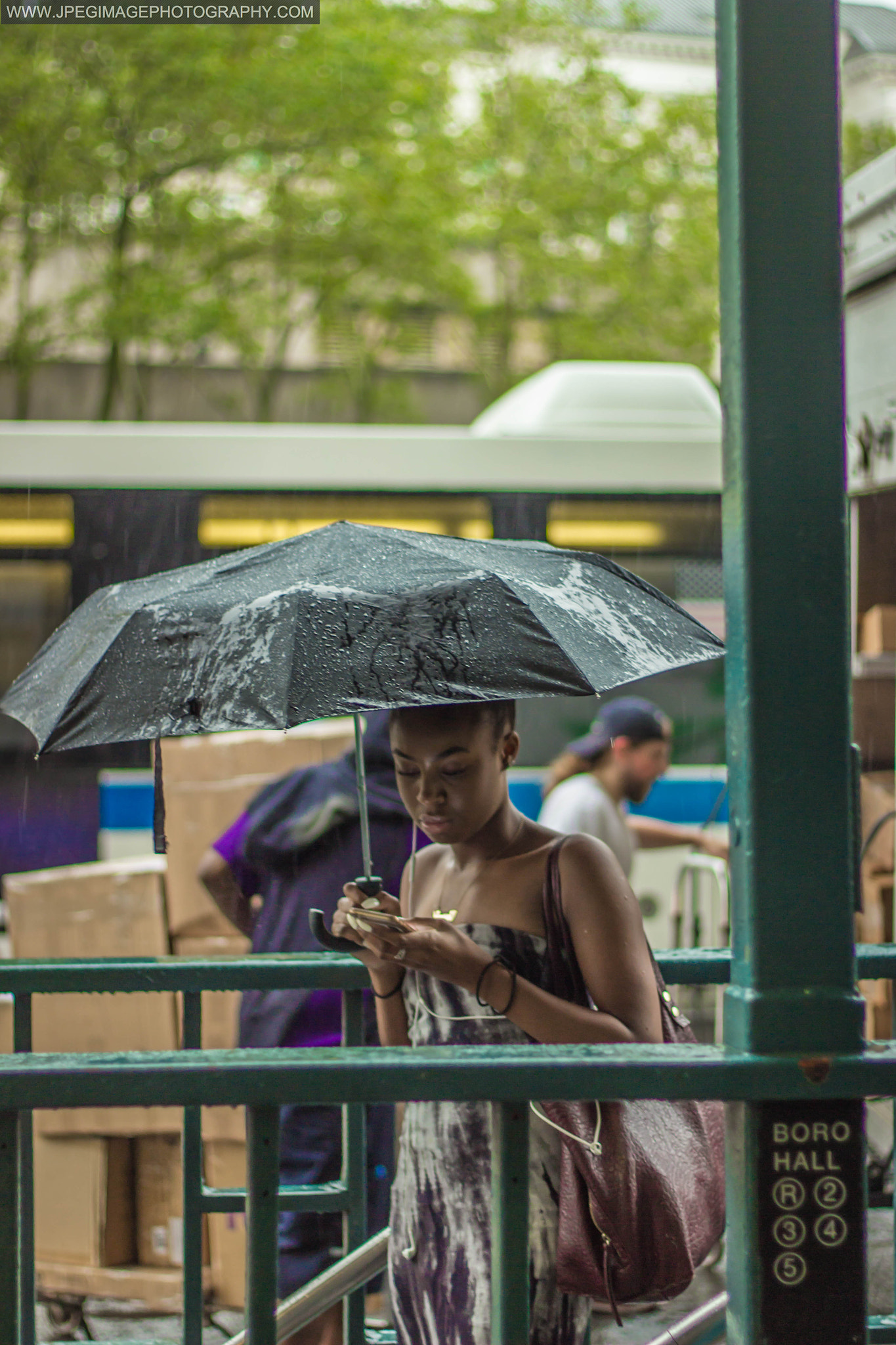 Canon EF 50mm F1.8 II sample photo. Young woman checking her cellphone before entering new york city subway. july 18, 2016 photography