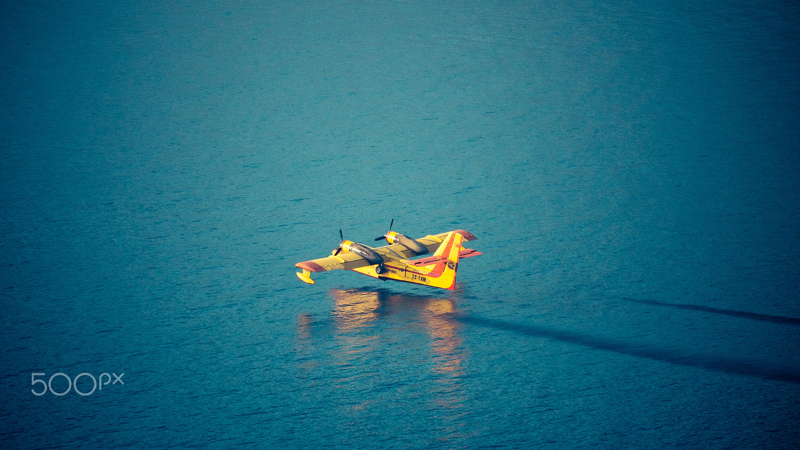 Panasonic Lumix DMC-GH4 sample photo. Aircraft firefighter take water in the sea photography