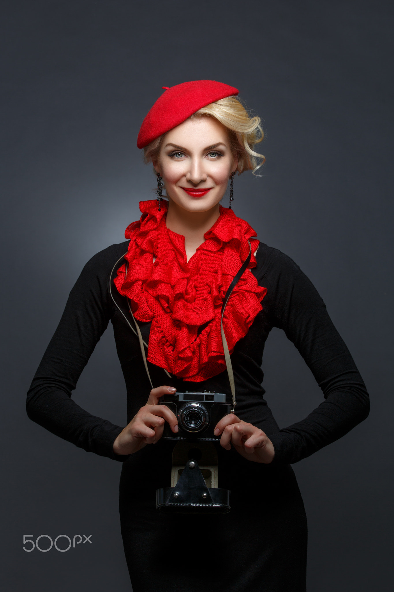 Beautiful lady with retro photo camera