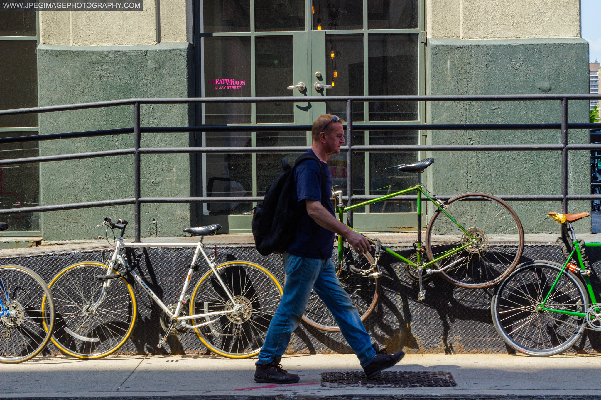 Canon EOS 600D (Rebel EOS T3i / EOS Kiss X5) + Canon EF 50mm F1.8 II sample photo. Man walking down a local street in dumbo brooklyn, new york. july 20, 2016 photography