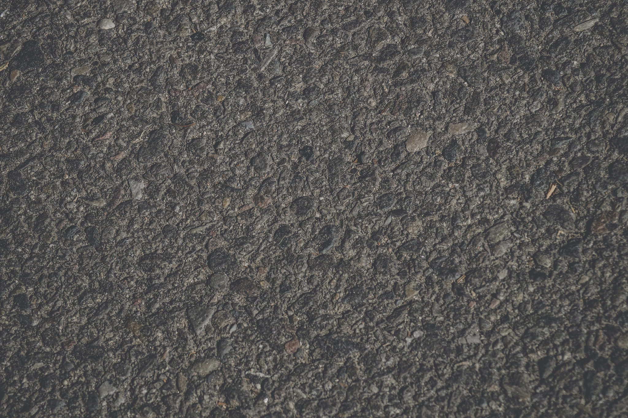 Sony 75-300mm F4.5-5.6 sample photo. Dark rough background with rocks photography