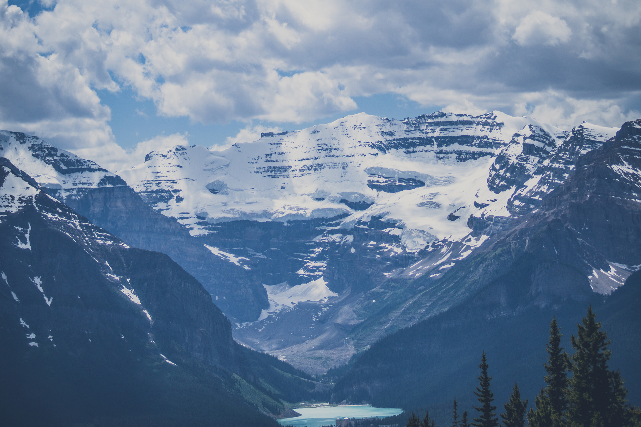 Sony 75-300mm F4.5-5.6 sample photo. Mountain peaks with snow and cloudy sky photography