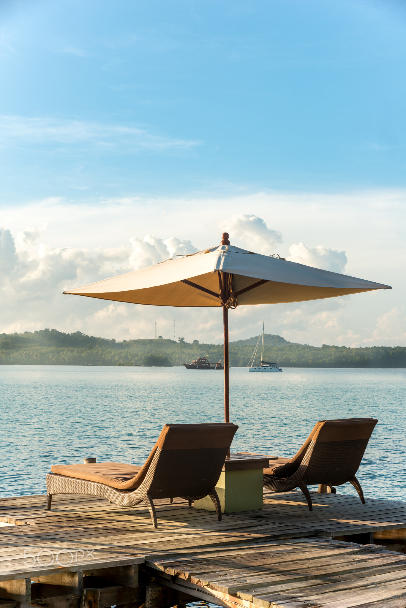 Tropical beach resort with lounge chairs and umbre