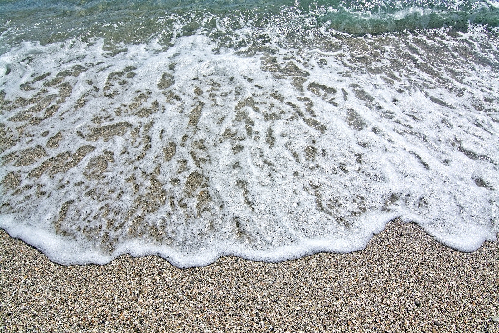 Nikon D7100 sample photo. Foamy wave hits rocks and seashells beach closeup photography