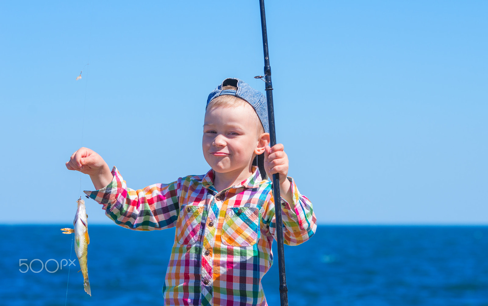 Pentax K-5 II sample photo. Little boy with mysterious sight holding a fishing pole with his photography