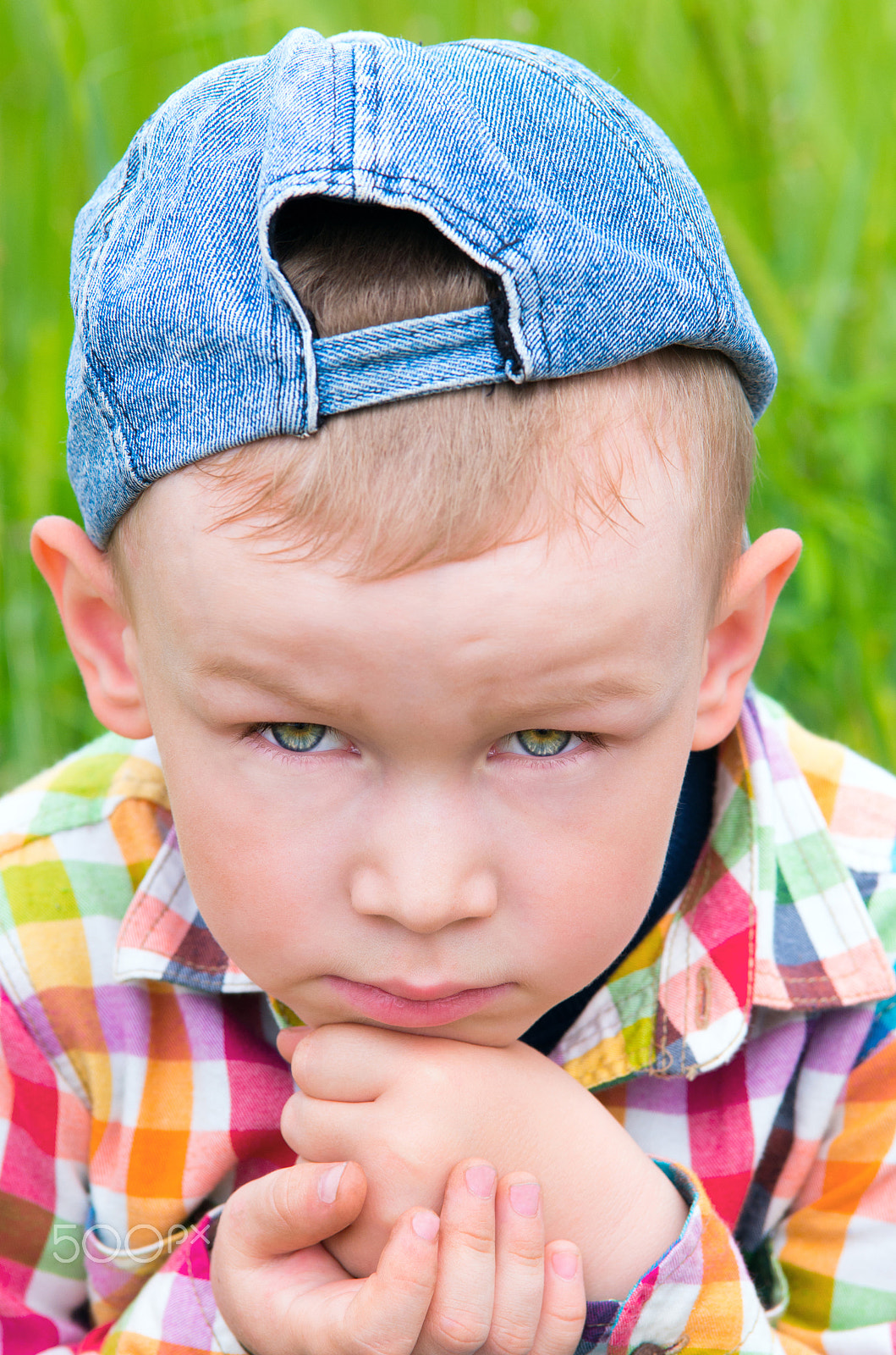 Pentax K-5 II sample photo. A little boy in a cap put his head on his hand and sad. photography