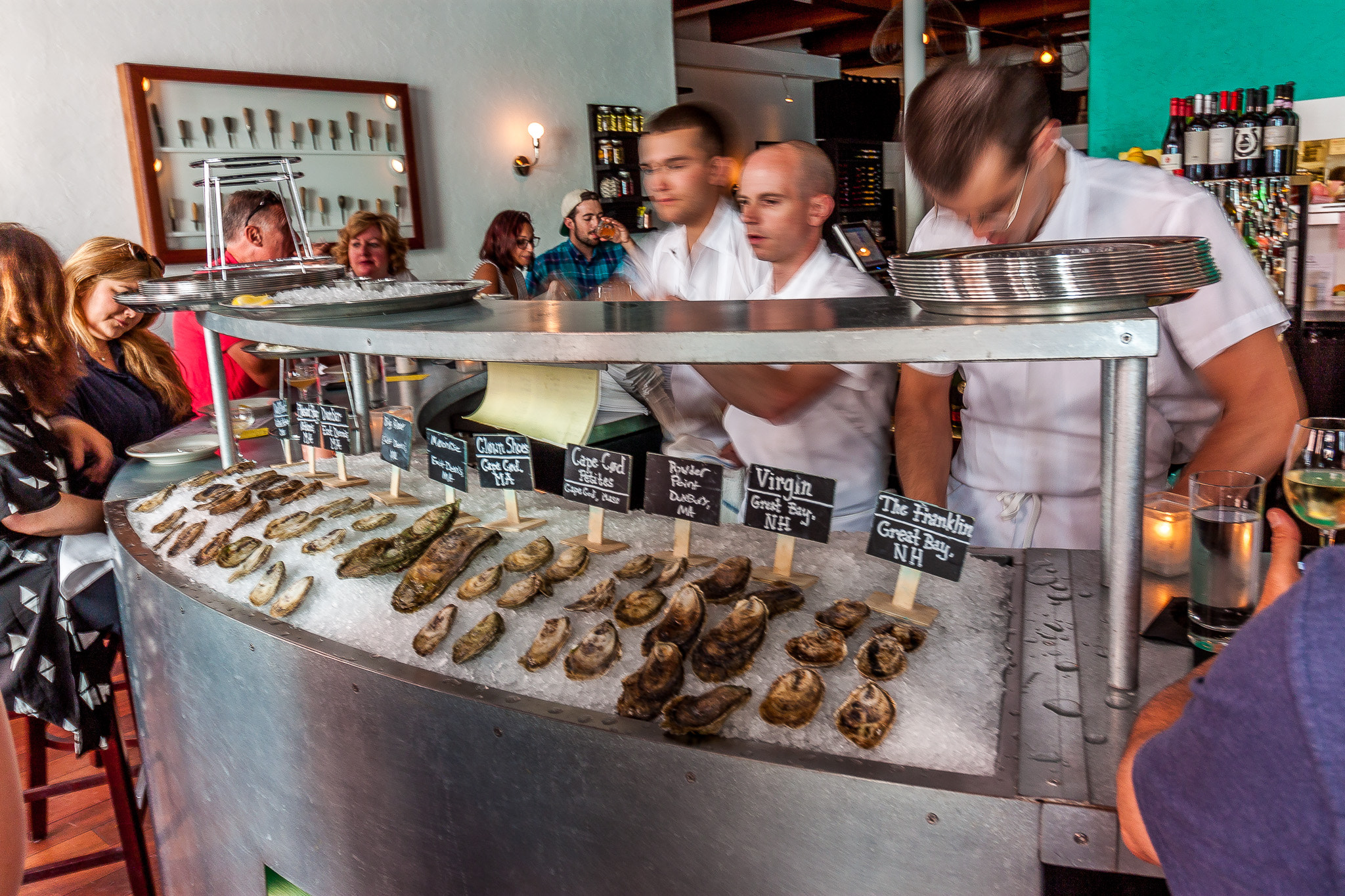 Canon EOS 500D (EOS Rebel T1i / EOS Kiss X3) sample photo. Three shuckers shucking photography
