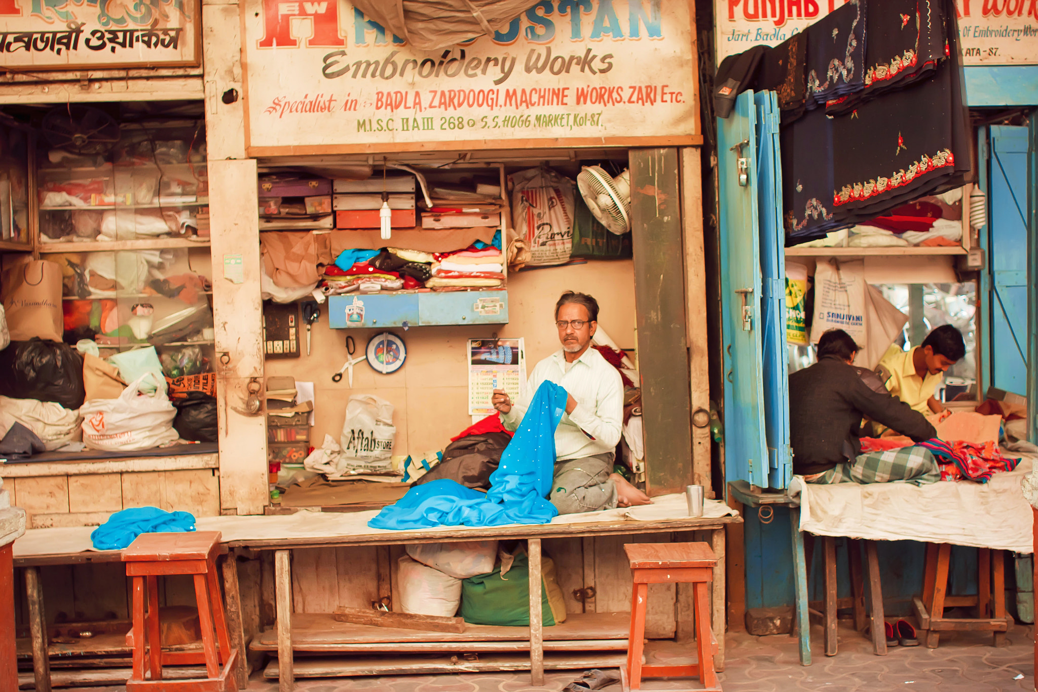 Canon EOS 40D + Canon EF 28mm F1.8 USM sample photo. Tailors sew clothes in small workshops photography