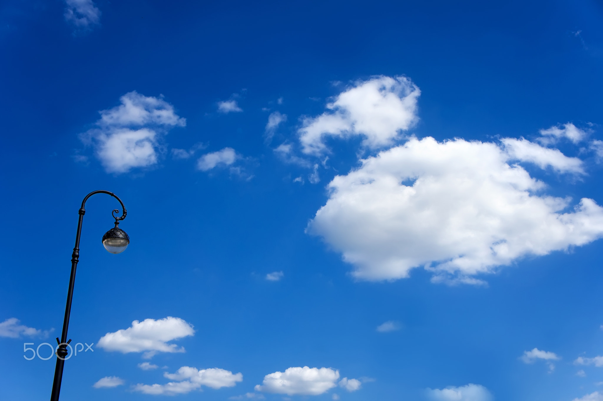 street lamppost against the blue sky