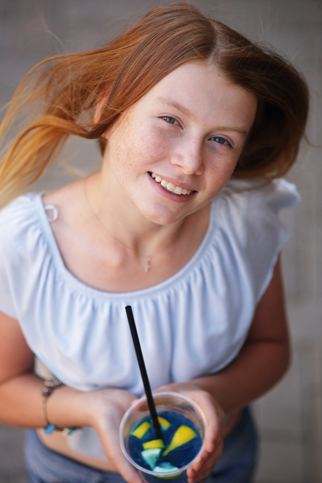 Canon EOS 6D + Canon EF 135mm F2.8 SF sample photo. Cute red-haired girl holding blue beverage with le photography