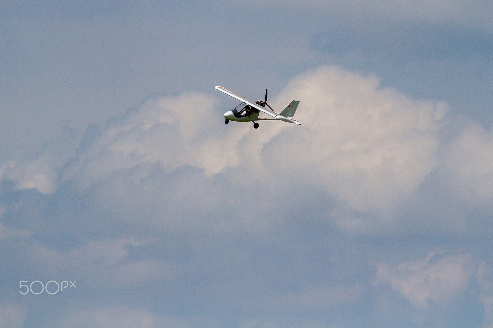 Canon EF 100-400mm F4.5-5.6L IS USM sample photo. Big clouds, small plane photography