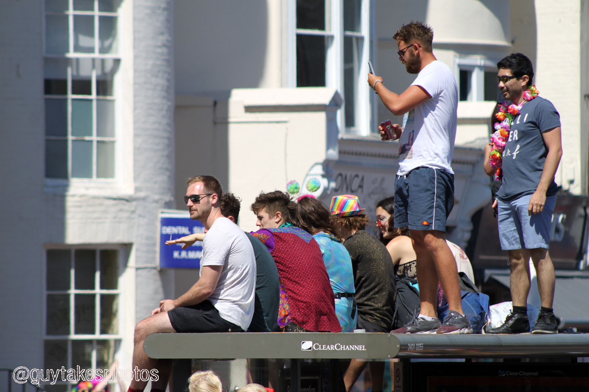 Canon EOS 500D (EOS Rebel T1i / EOS Kiss X3) + Canon EF 100-300mm F4.5-5.6 USM sample photo. Observers on a bus shelter at brighton pride 2016 photography