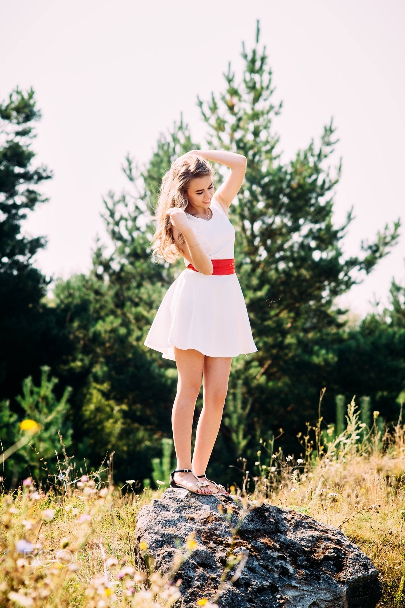 Beautiful model posing in the bosom of green nature