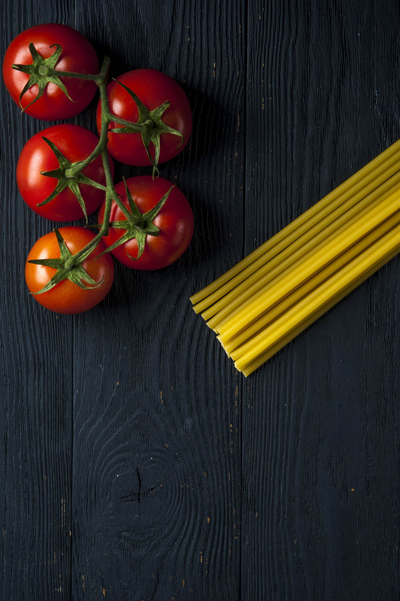 Nikon D700 + AF Micro-Nikkor 105mm f/2.8 sample photo. Bundle of uncooked pasta and tomatoes photography