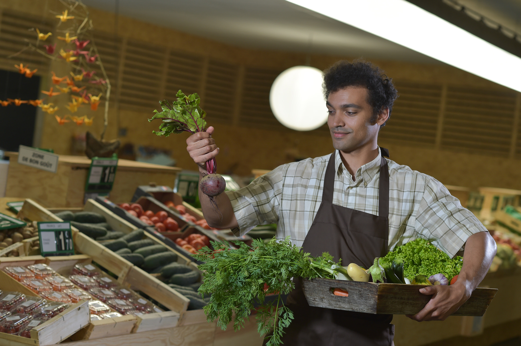 Nikon D4S + Nikon AF-S Nikkor 85mm F1.4G sample photo. Grocery clerk working in produce aisle of supermarket store photography