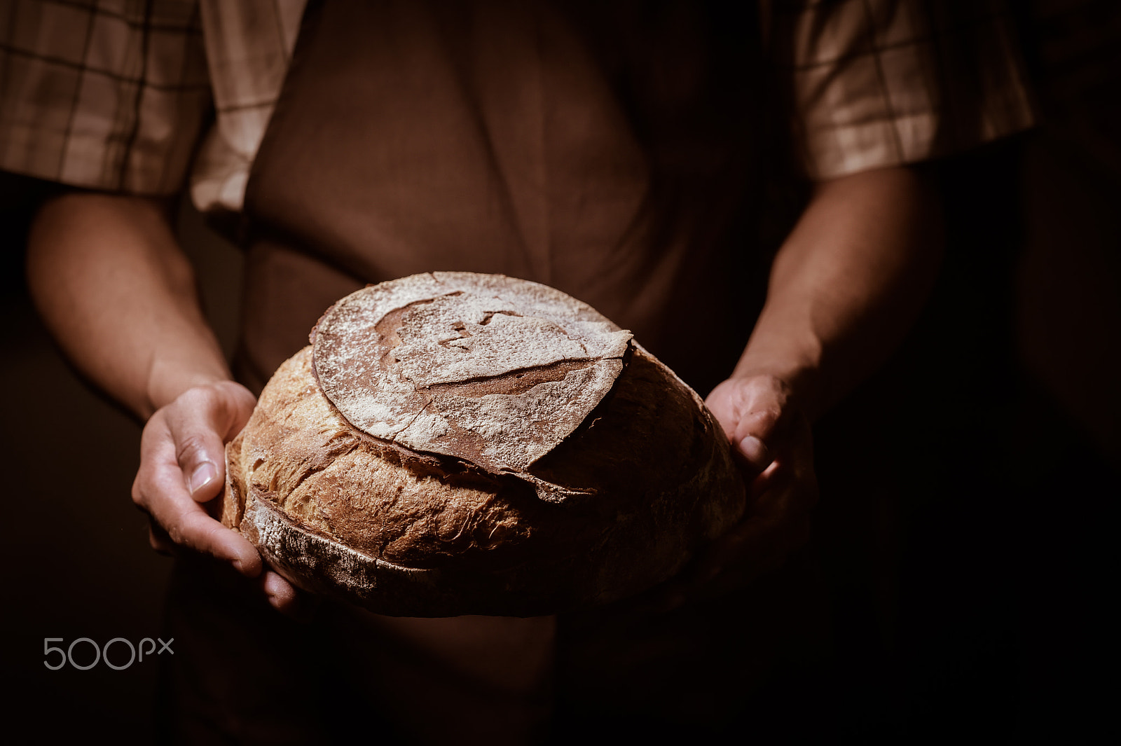 Nikon D4S + Nikon AF-S Nikkor 85mm F1.4G sample photo. Baker man holding a round bread photography