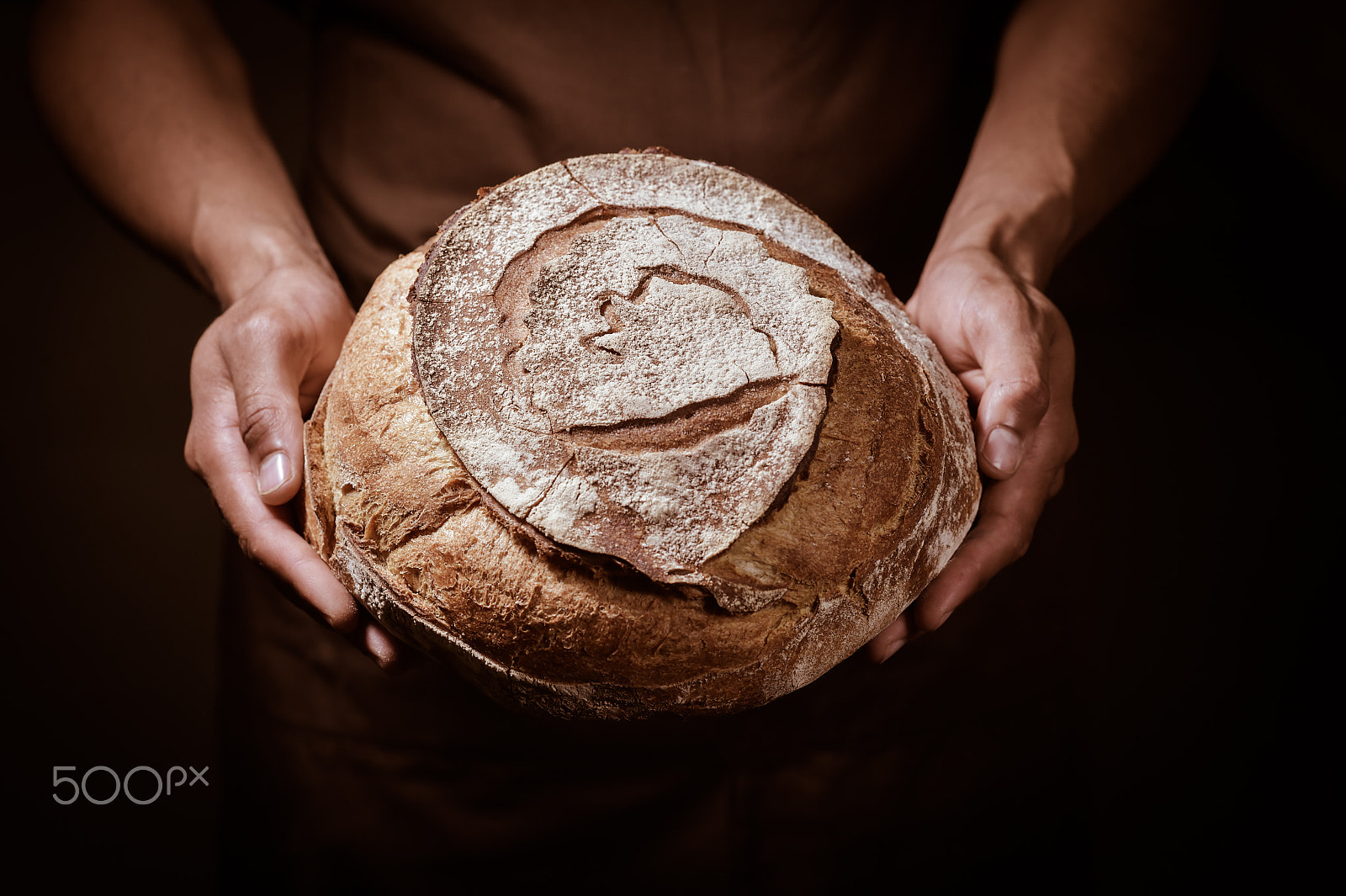 Nikon D4S + Nikon AF-S Nikkor 85mm F1.4G sample photo. Baker man holding a round bread photography